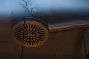 Circular metal vent connected to HVAC ductwork