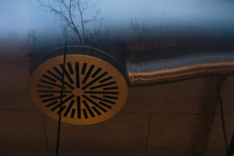 Circular metal vent connected to HVAC ductwork