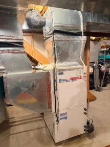 Furnace in a basement with ductwork, illustrating how it heats homes in New Jersey during winter