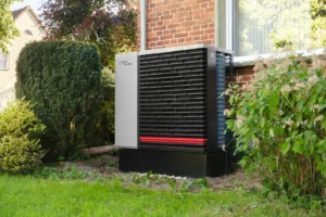 Outdoor heat pump unit next to a brick home