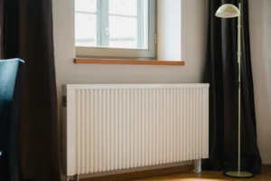 White radiator in a room heated by an oil boiler